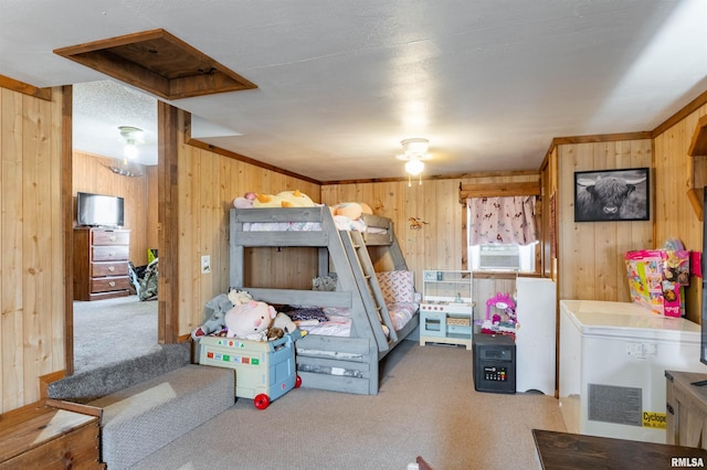 bedroom featuring wood walls and carpet floors