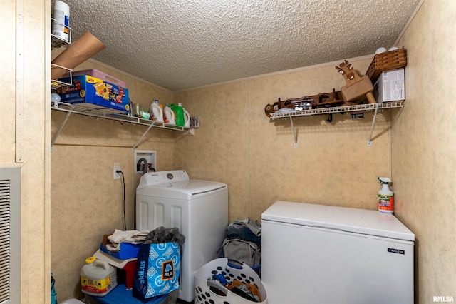 laundry area with a textured ceiling and washer and clothes dryer