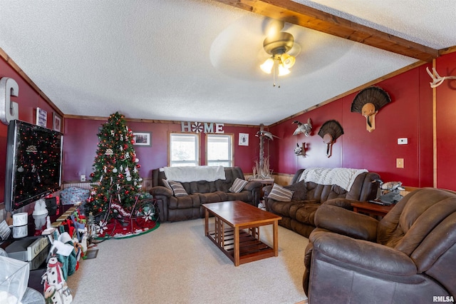 carpeted living room featuring vaulted ceiling with beams, a textured ceiling, ceiling fan, and ornamental molding