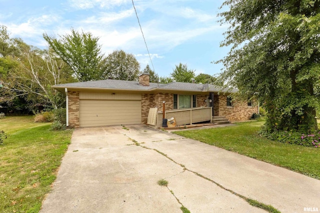 view of front of property featuring a front yard, concrete driveway, brick siding, and an attached garage