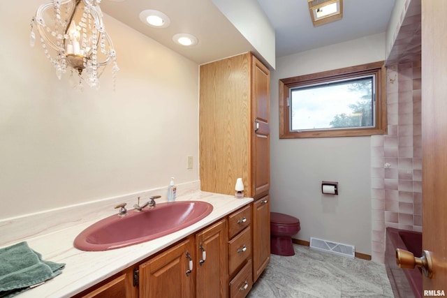 bathroom featuring baseboards, visible vents, vanity, and toilet