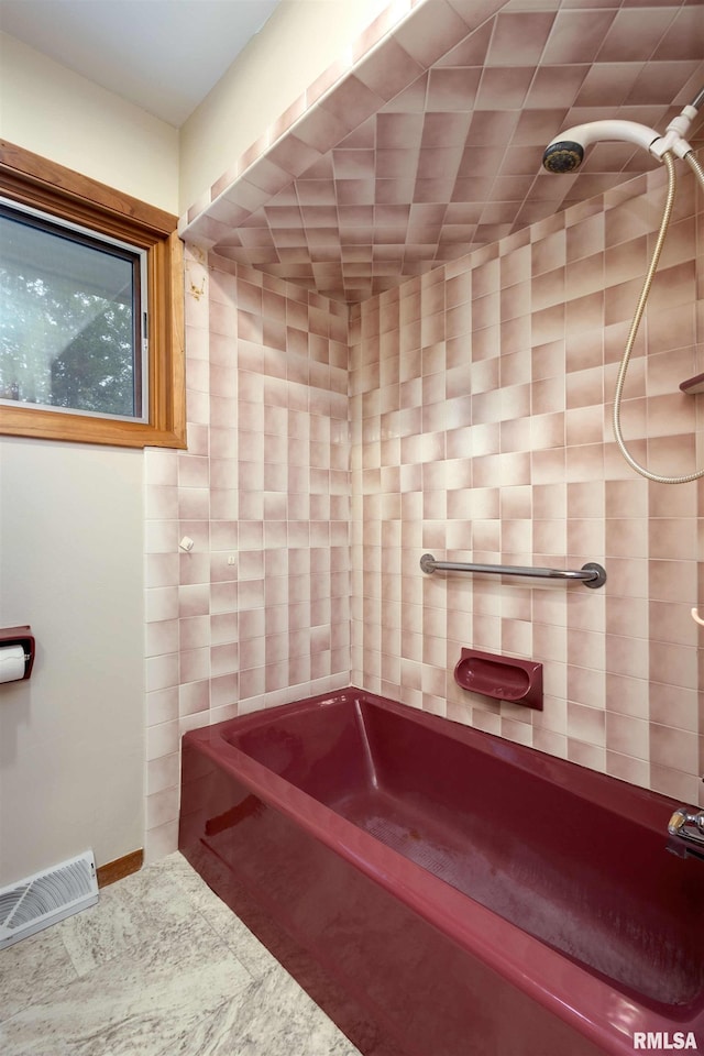 bathroom with shower / tub combination and visible vents