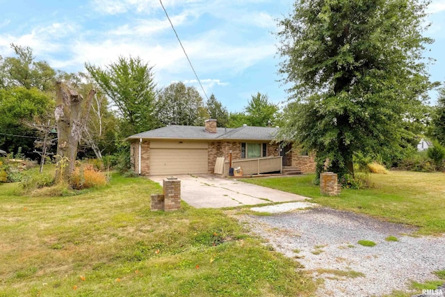 view of front of house featuring a garage, brick siding, concrete driveway, a chimney, and a front yard