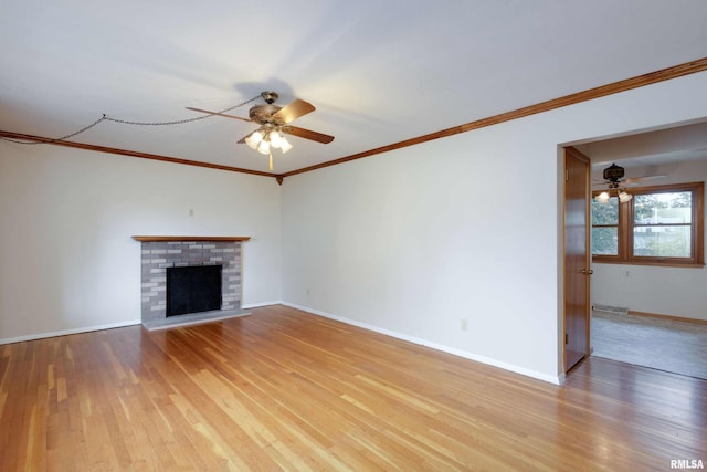 unfurnished living room with a fireplace, visible vents, light wood-style floors, ceiling fan, and baseboards