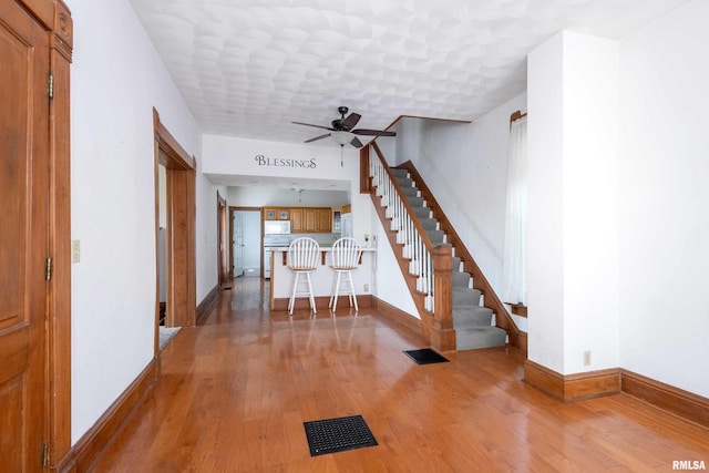 interior space with ceiling fan and light hardwood / wood-style flooring