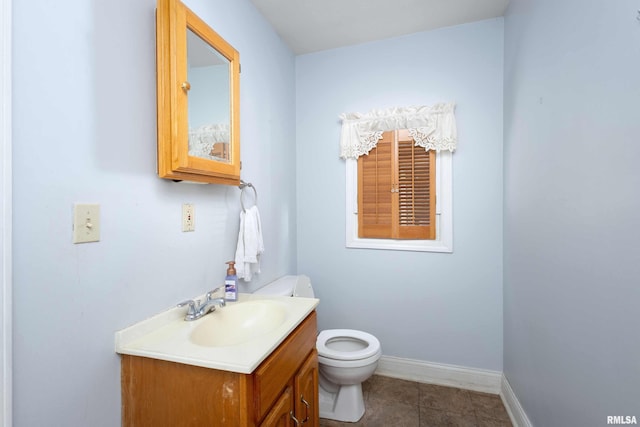 bathroom featuring tile patterned flooring, vanity, and toilet