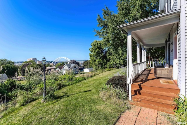 view of yard featuring covered porch