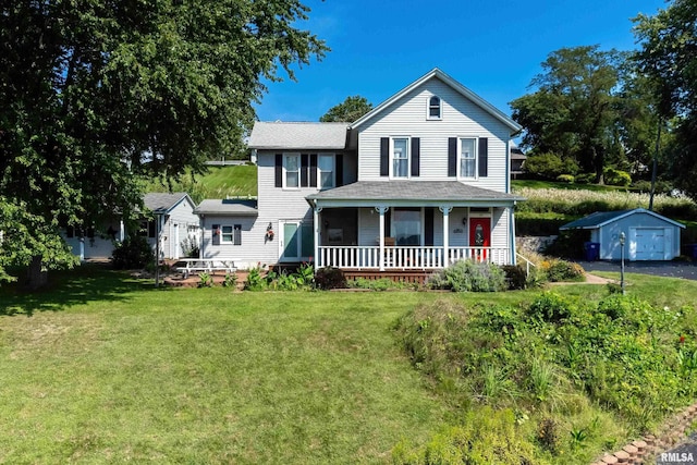 view of front of house with an outbuilding, covered porch, and a front yard