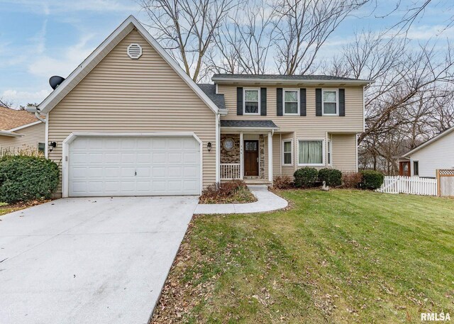 view of front of property with a garage and a front yard