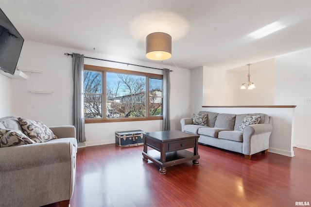 living room featuring dark hardwood / wood-style floors and a chandelier