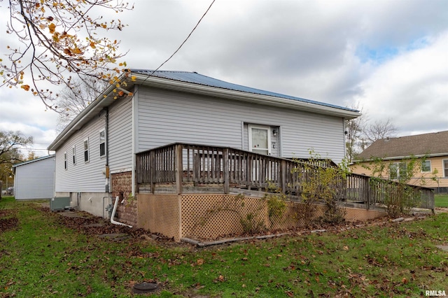 back of property featuring a yard, central AC unit, and a wooden deck