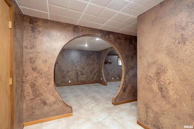 hallway featuring a paneled ceiling