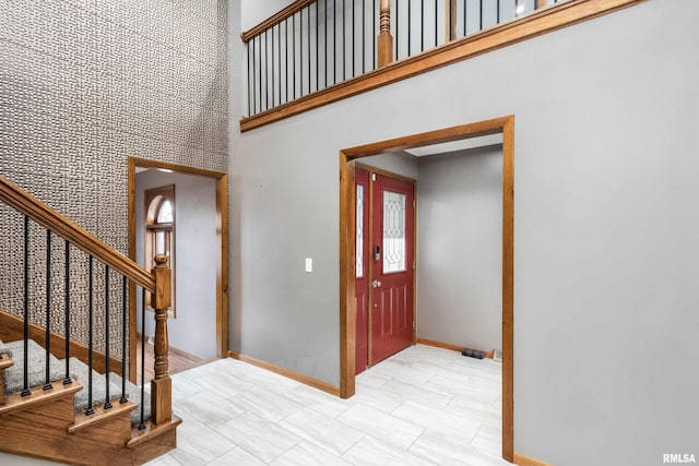 foyer featuring a towering ceiling