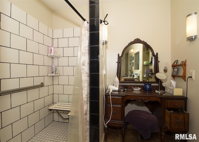 bathroom with tile patterned floors, curtained shower, and tile walls