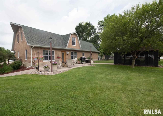 back of house featuring a yard and a patio