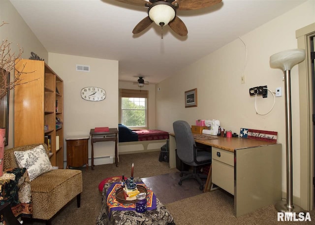 home office featuring dark colored carpet, baseboard heating, and ceiling fan