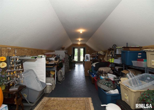 bonus room with french doors, a textured ceiling, and vaulted ceiling