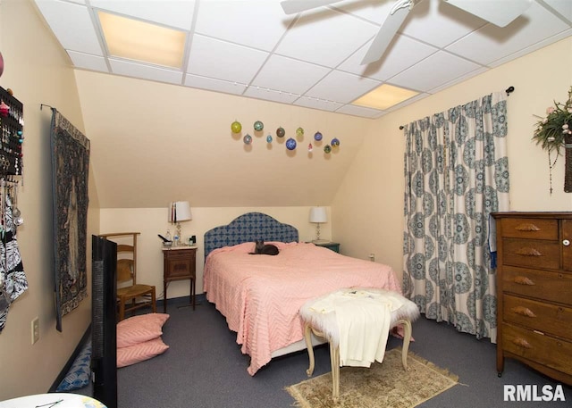 carpeted bedroom featuring a drop ceiling