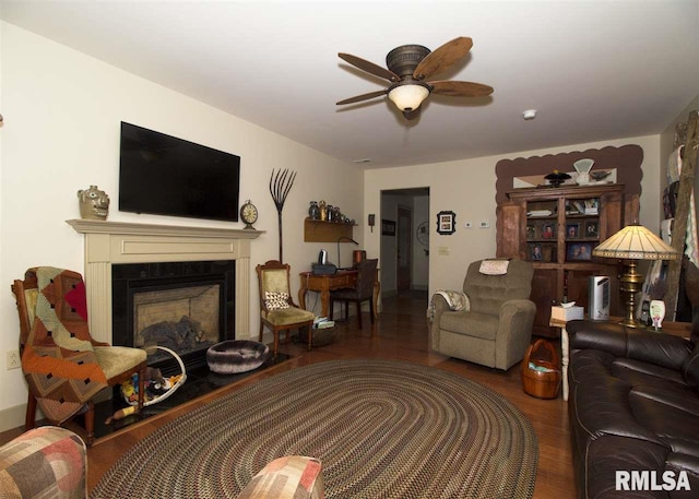 living room with ceiling fan and dark wood-type flooring