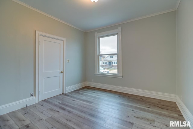 unfurnished room featuring light hardwood / wood-style floors and crown molding