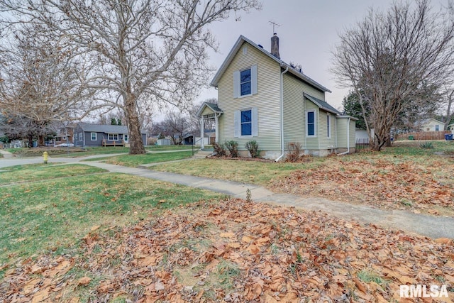 view of side of property featuring a yard