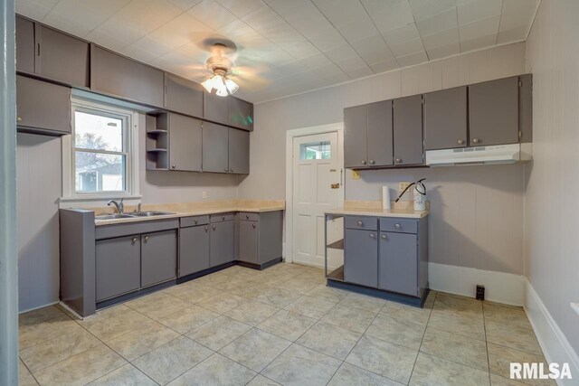 1700 Pershing Blvd, Clinton, IA 52732 - kitchen featuring gray cabinets, under cabinet range hood, plenty of natural light, and open shelves