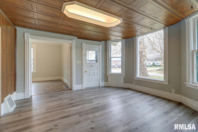 interior space with wood ceiling, wooden walls, and light hardwood / wood-style flooring