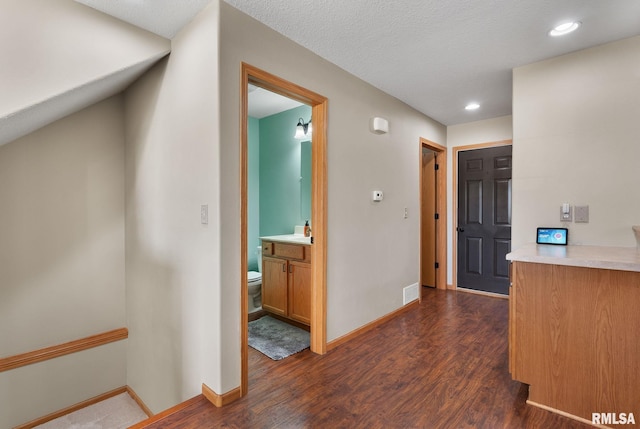 hall featuring dark hardwood / wood-style flooring and a textured ceiling