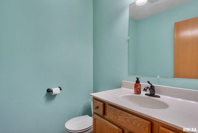 bathroom featuring vanity and toilet