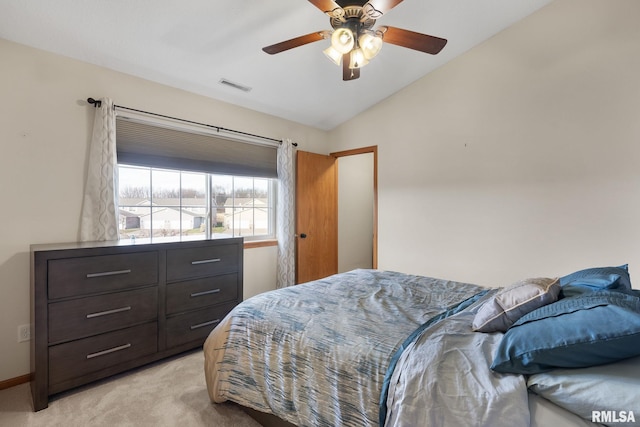 bedroom with light carpet, vaulted ceiling, and ceiling fan