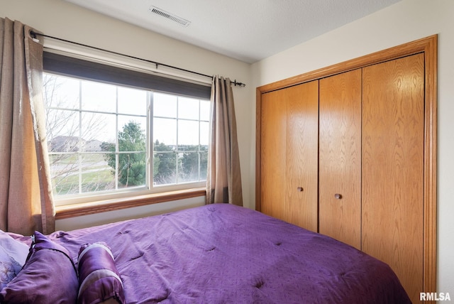 bedroom with a closet and a textured ceiling