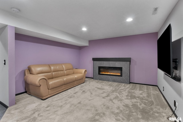 carpeted living room with a tiled fireplace