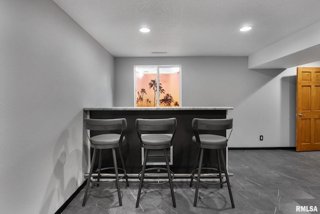 bar with a textured ceiling