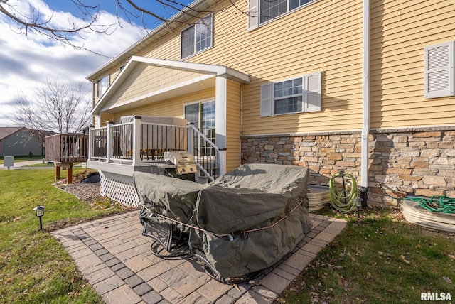 exterior space with a deck and a lawn