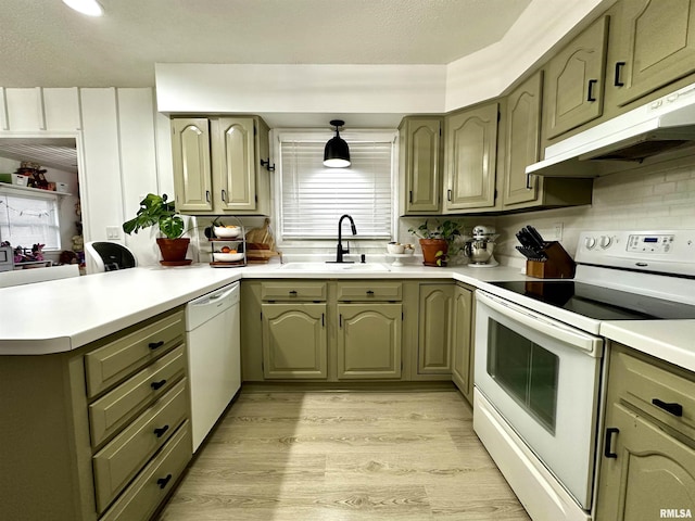 kitchen with sink, kitchen peninsula, white appliances, decorative backsplash, and light wood-type flooring