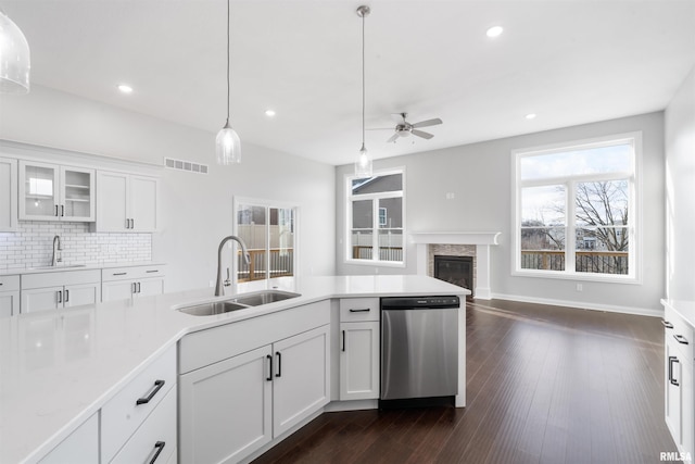 kitchen featuring white cabinetry, sink, stainless steel dishwasher, and dark hardwood / wood-style floors