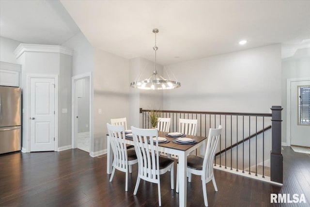 dining room featuring dark hardwood / wood-style flooring, lofted ceiling, and a notable chandelier