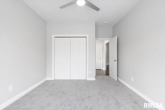 unfurnished bedroom with carpet, a closet, and ceiling fan