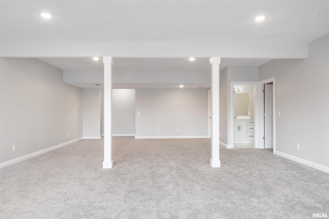 basement featuring light colored carpet