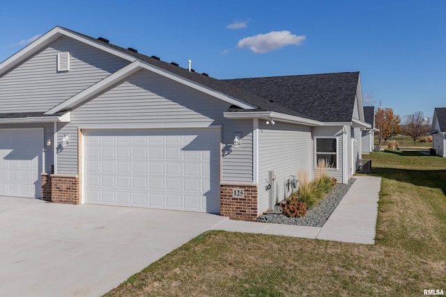 view of home's exterior featuring a lawn and a garage