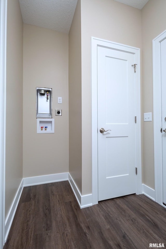 laundry room with dark hardwood / wood-style flooring, a textured ceiling, hookup for a washing machine, and electric dryer hookup