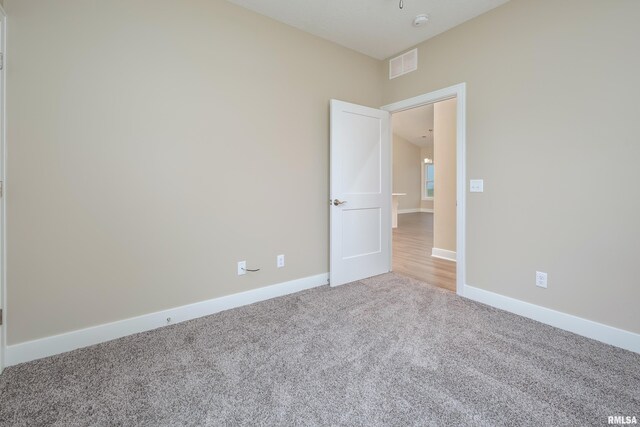 125 Beacon Harbor Cir, East Moline, IL 61244 - unfurnished room with light colored carpet, visible vents, and baseboards