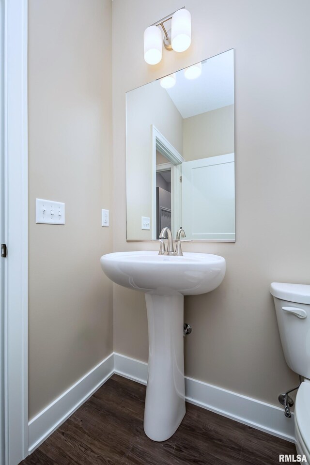 125 Beacon Harbor Cir, East Moline, IL 61244 - half bathroom featuring baseboards, wood finished floors, and toilet