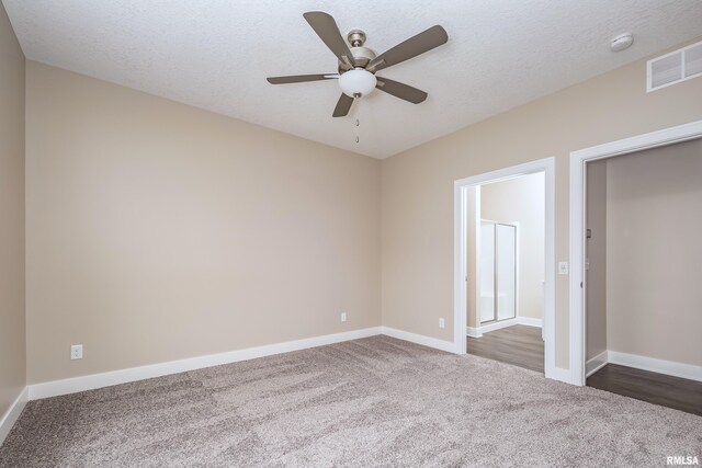 125 Beacon Harbor Cir, East Moline, IL 61244 - unfurnished bedroom with carpet floors, a textured ceiling, baseboards, and visible vents