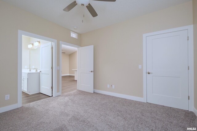 125 Beacon Harbor Cir, East Moline, IL 61244 - unfurnished bedroom featuring carpet, baseboards, connected bathroom, visible vents, and a ceiling fan