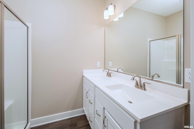 125 Beacon Harbor Cir, East Moline, IL 61244 - bathroom featuring a sink, a shower with door, baseboards, and wood finished floors