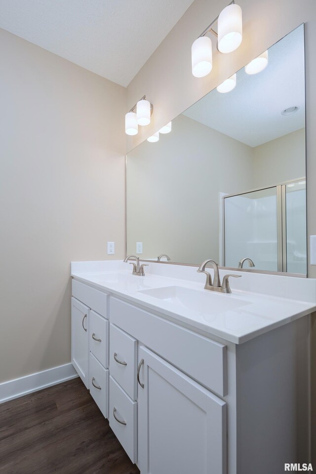125 Beacon Harbor Cir, East Moline, IL 61244 - full bath with baseboards, double vanity, a sink, and wood finished floors