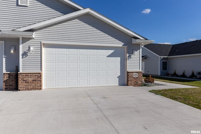 125 Beacon Harbor Cir, East Moline, IL 61244 - view of front of property with brick siding, concrete driveway, and an attached garage