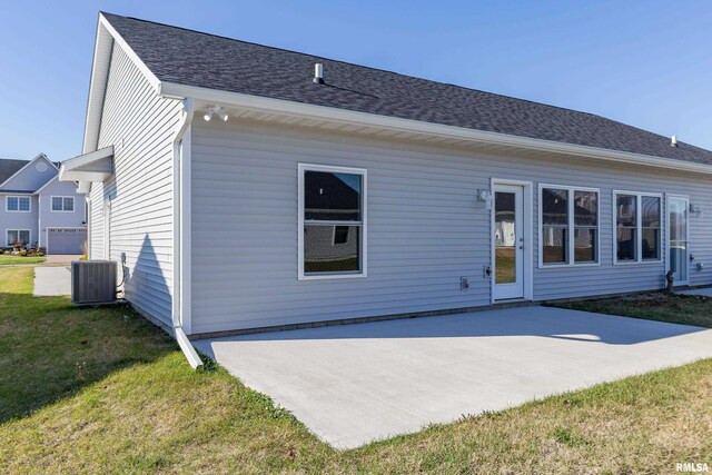 125 Beacon Harbor Cir, East Moline, IL 61244 - rear view of house featuring central AC unit, a yard, and a patio area