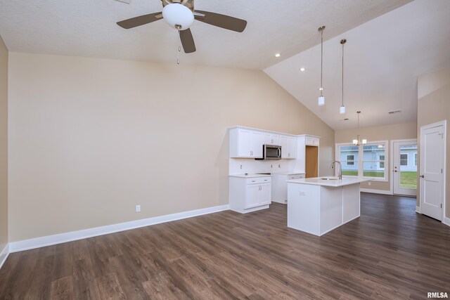 125 Beacon Harbor Cir, East Moline, IL 61244 - kitchen featuring stainless steel microwave, dark wood-type flooring, ceiling fan, white cabinets, and a kitchen island with sink
